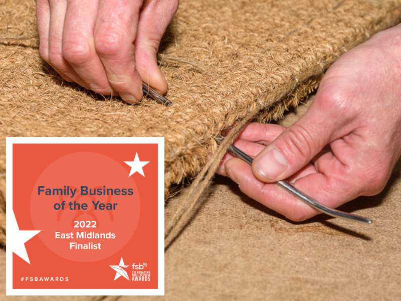 Hands stitching a coir mat