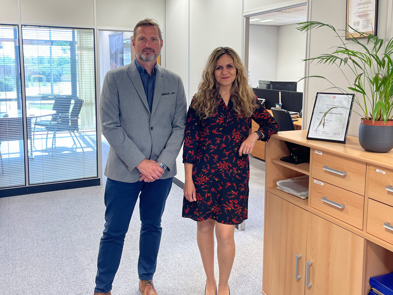 Jay and Shari standing in YMD Boon's new Lincoln Office